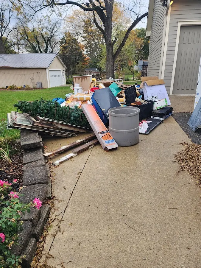 Dumpster being loaded with debris for Estate Cleanout Dumpster Rental in Atlanta